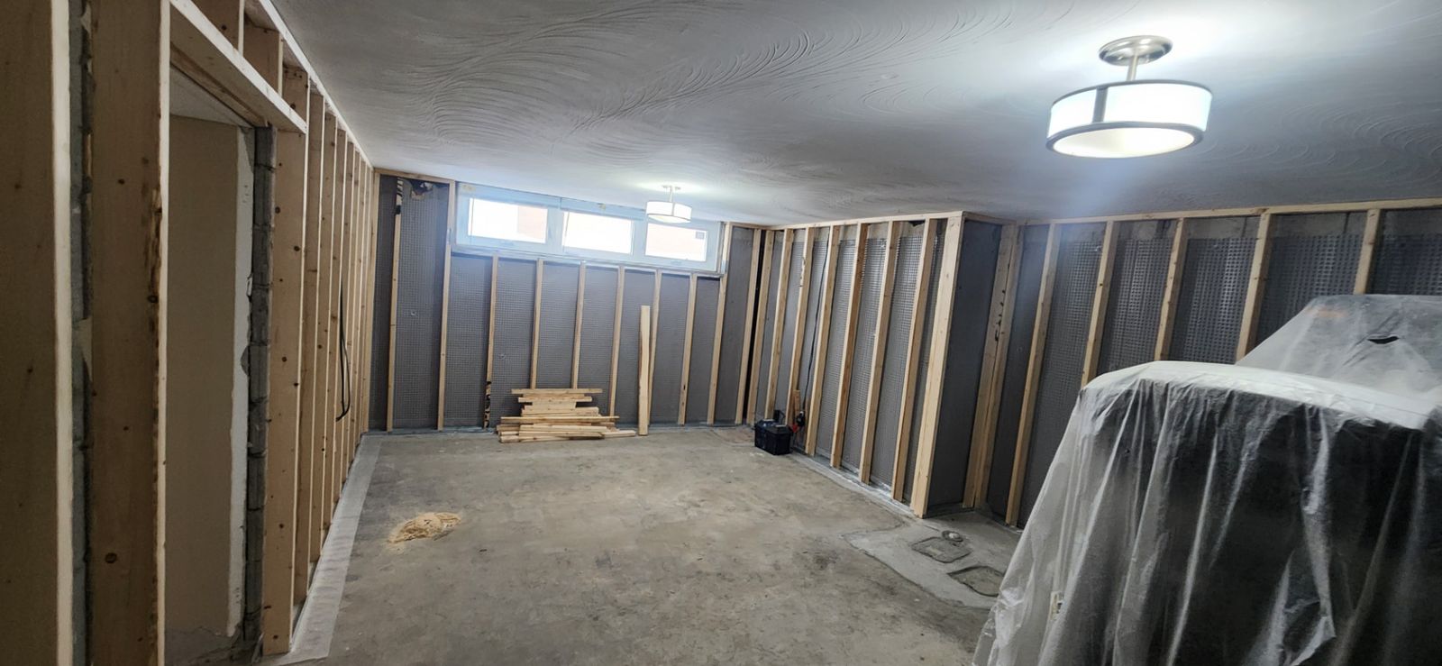 Before: Living area — finished walls, protected workspace